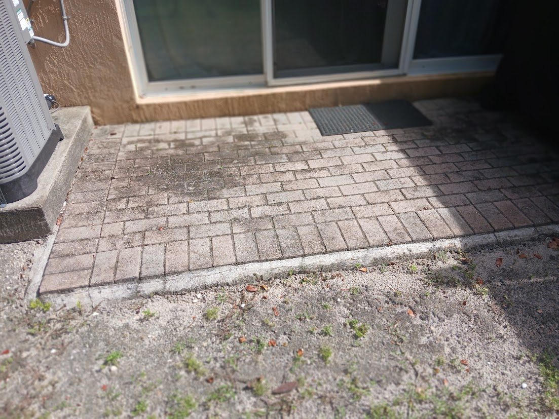 Paver patio before pressure washing